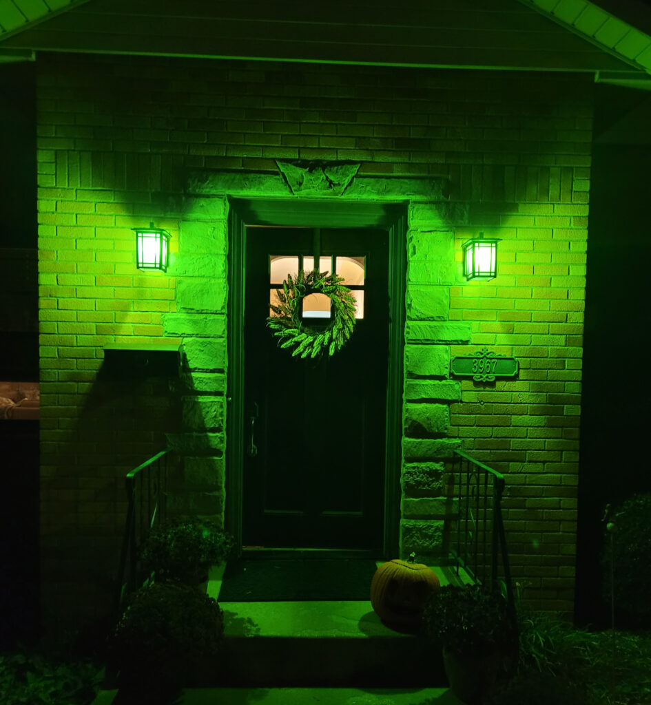 Front door to a house with green lights